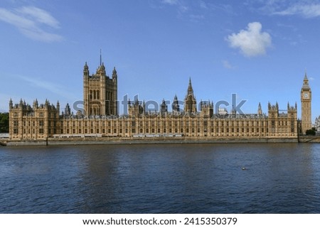 Big Ben and Parliament across the Thames River and Westminster Bridge in London, UK.