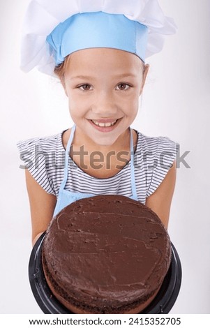Kid, baker and portrait with cake, happy and confident with child development on white background. Culinary skills, satisfied and baking dessert and childhood with chocolate in hospitality industry Royalty-Free Stock Photo #2415352705