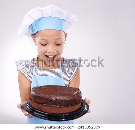 Kid, baker and excited with cake, happy and confident with child development on white background. Culinary skills, satisfied and baking dessert and childhood with confidence in hospitality industry Royalty-Free Stock Photo #2415352879