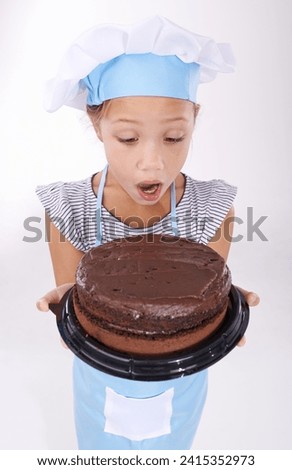 Kid, baker and shocked with cake, happy and confident with child development on white background. Culinary skills, satisfied and baking dessert and childhood with confidence in hospitality industry Royalty-Free Stock Photo #2415352973