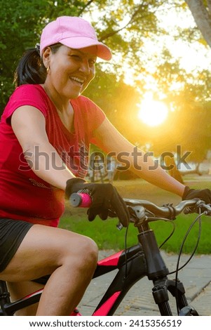Hispanic Latin brunette woman winking right eye with sun in the background in Neiva park - Huila - Colombia