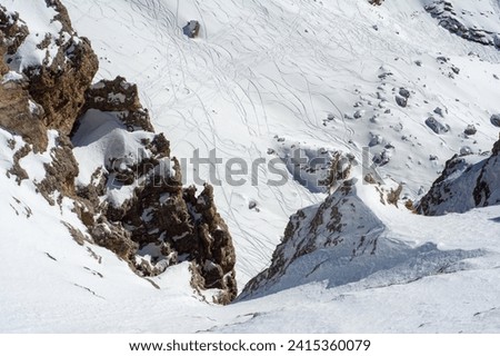 Ski resort in the Dolomites. Mountain recreation place. Ski slopes in the Dolomites on a clear sunny day. Alpine skiing sport and recreation. Snowboard track Royalty-Free Stock Photo #2415360079