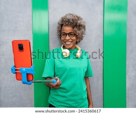 American African woman influencer making a direct on the street with smartphone
