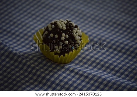 Brigadeiro (Brigadier), tasty Traditional Brazilian homemade candy. Chocolate candies for birthday and wedding party in colored paper form