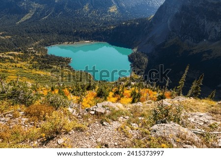 Beautiful Grinnell Lake in montana with autumn colors in the forest