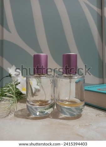 empty perfume bottle with flower and book decoration