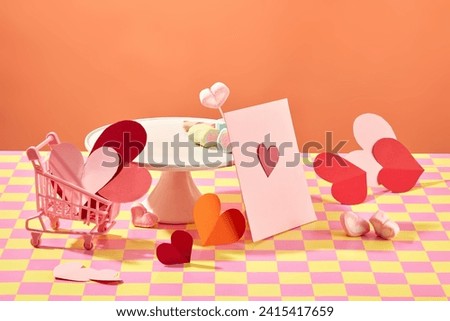Happy Valentine's day or Women's day concept with a lot of origami paper in heart shaped decorated with marshmallows. A pink card featured. Blank space for product advertising