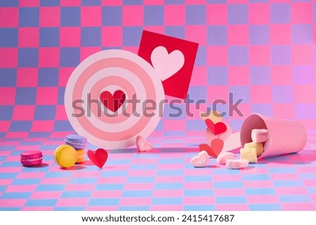 On purple and pink checkered background, sweet cakes, marshmallow and cute decorations displayed. Front view, background for advertising product with valentine’s concept