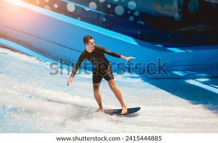 Young man surfing on a wave simulator at a water amusement park