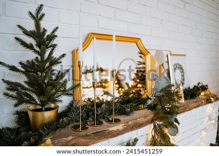 Christmas tree in a pot, garland of spruce branches, candlesticks, garland. Winter holidays. Interior picture. New year and Christmas. High quality photo