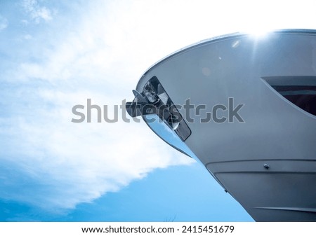Motor yacht moored for repairs and service in dry dock Royalty-Free Stock Photo #2415451679