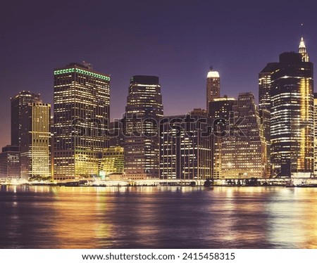 Manhattan waterfront skyline at night, color toning applied, New York City, USA.