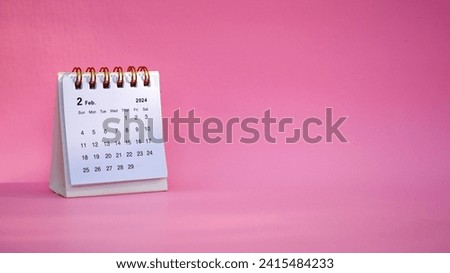 Desk calendar for February 2024 on a pink background with copy space. Royalty-Free Stock Photo #2415484233