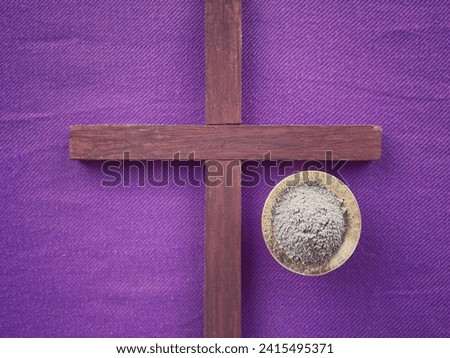 Christianity concept about Ash Wednesday, Good Friday, Lent Season and Holy Week. A holy cross and holy ash on a purple background . With blurred style background.