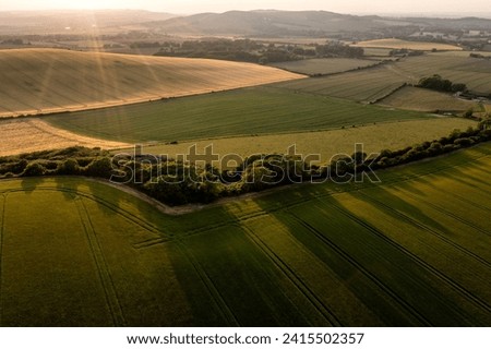 Beautiful Summer aerial drone landscape image of English countryside surrounding Firle Beacon in South Downs National Park