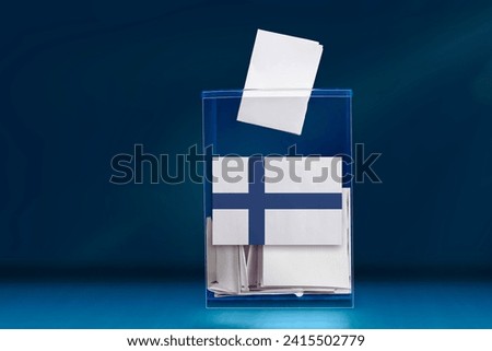 A ballot box with ballots on Election Day, flag Finland. Royalty-Free Stock Photo #2415502779