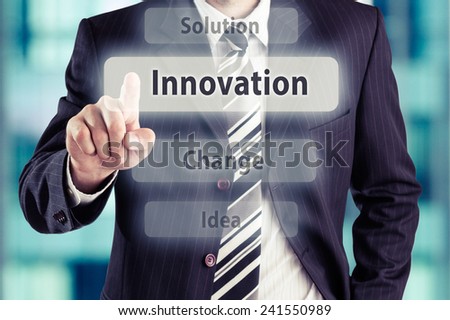 Business man pressing innovation button at his office. Innovation concept, toned photo.