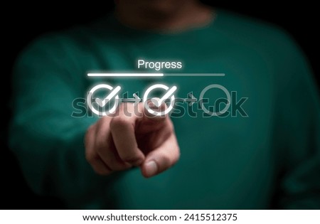 Businessman touching to tick correct mark in checklist with progressive loading status to remind work task progressive for project develop management and tracking concept.  Royalty-Free Stock Photo #2415512375