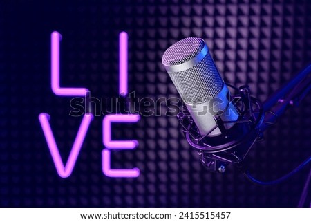 Professional microphone in the sound recording studio with LIVE neon sign.