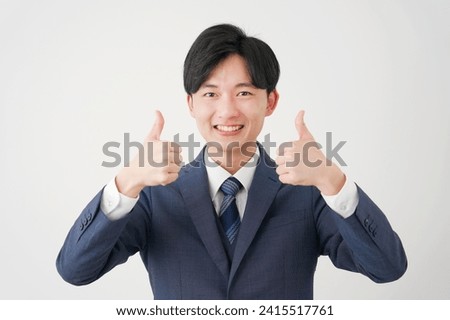 Asian businessman thumbs up gesture in white background