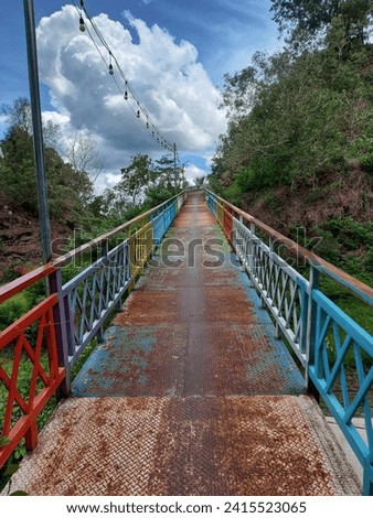 bridge over a colorful mountain with beautiful pine trees