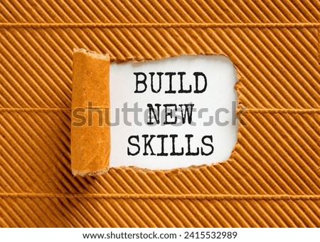 Build new skills symbol. Concept word Build new skills on beautiful white paper. Beautiful brown table brown background. Business, education build new skills concept. Copy space.