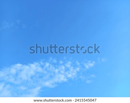 blue sky with white clouds, forming an acute angle Royalty-Free Stock Photo #2415545047