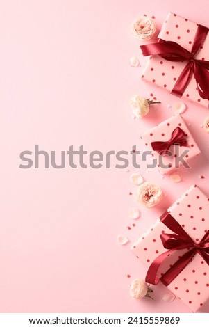 Valentine's Day vertical banner with gift boxes and flowers on pink background.