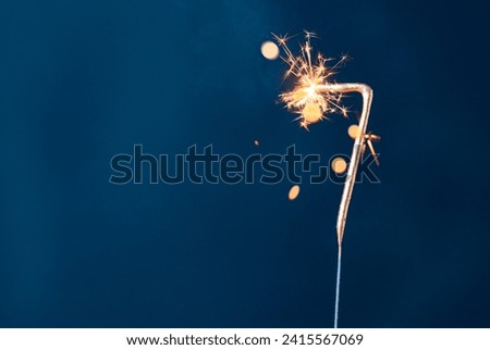 7 years celebration festive background made with Bengal fires in the form of number Seven. Royalty-Free Stock Photo #2415567069