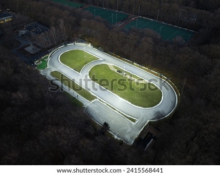 Oval ice skating rink, winter sport ice skating club track. Birds eye aerial drone view from above. Doorn, The Netherlands.