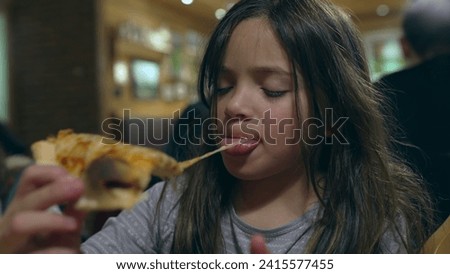 Children grabbing slice of pizza at restaurant, siblings about to eat carb food at diner. Little girl eating pizza