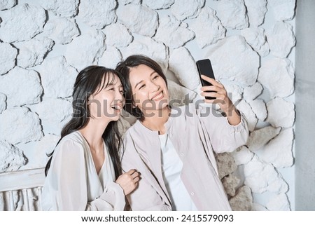 Women looking at smartphone screen