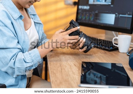 young woman working independently, editing a video at home