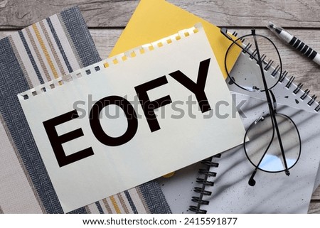 EOFY, Business concept yellow notepad and glasses on the table. text on a notepad.
