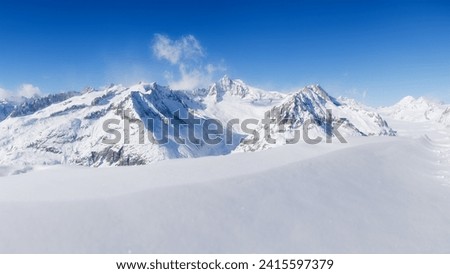 Winter mountain landscape. Wallpaper or background. Clear sky. Cold weather and frost. High rocks and snow. View of mountains. 