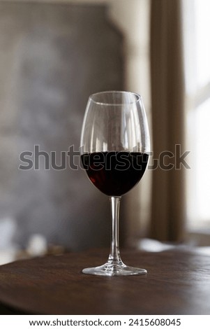 Low angel view of glass with red wine in the bar