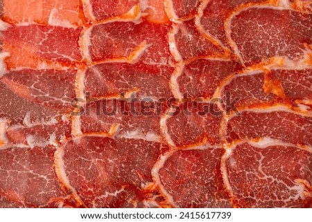 Iberian acorn loin sausage close up, background, Royalty-Free Stock Photo #2415617739