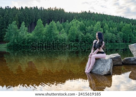 a pretty young woman with swimwear at the lake in the summer