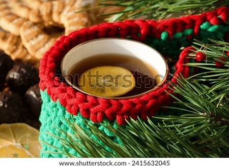 A cup of tea with lemon on a background of chocolates and cookies. Beautiful and romantic picture.