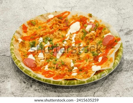 banh trang nuong pizza served in dish isolated on grey background top view of singapore seafood Royalty-Free Stock Photo #2415635259