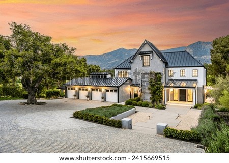 This stylish modern mansion has a unique stone driveway and offers a sophisticated layout Royalty-Free Stock Photo #2415669515