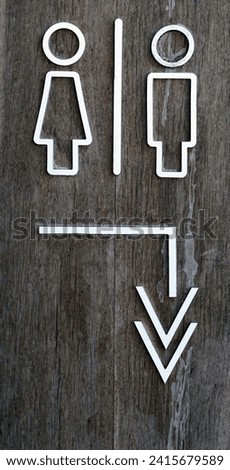 Male and female toilet sign on old wooden background, facility concepts.