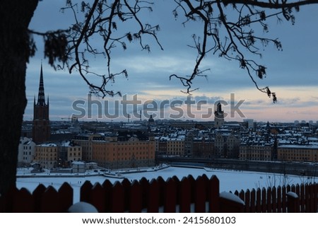 Stockholm Sweden January 20 2024 Winter, snow, ice, sunny in center of Stockholm. People walk on snow-covered ice in between the islands. Riddarholmen and the Old Town in the background GoranOfSweden