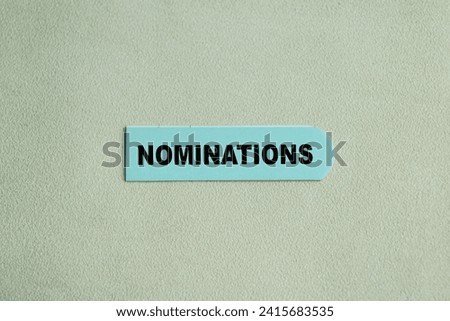 Concept of Nominations write on sticky notes isolated on Wooden Table.