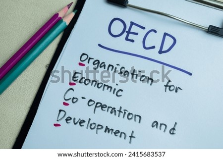 Concept of OECD - Organisation for Economic Co-operation and Development write on paperwork isolated on wooden background. Royalty-Free Stock Photo #2415683537