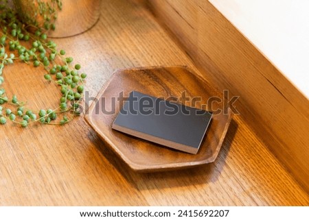 Stack of Black Business Cards in Wooden Plate