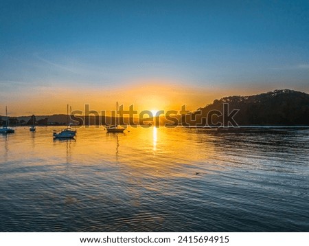 Sunrise waterscape at the channel in Ettalong Beach on the Central Coast, NSW, Australia. Royalty-Free Stock Photo #2415694915
