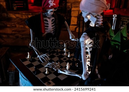Two prop skeletons playing chess haloween aesthetic photo