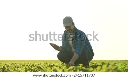 farmer field works with tablet sunset. Agriculture. farm work agro-industry. eco. agrarian farmer rubber boots works field. farmer smile. pharming concept. rural business. working man field sunset. Royalty-Free Stock Photo #2415711707