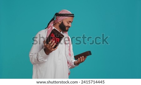 Muslim adult opening giftbox with bow, receiving sweet present on his birthday. Middle eastern cheerful person feeling excited about gift wrapped with ribbon, amazing holiday package.